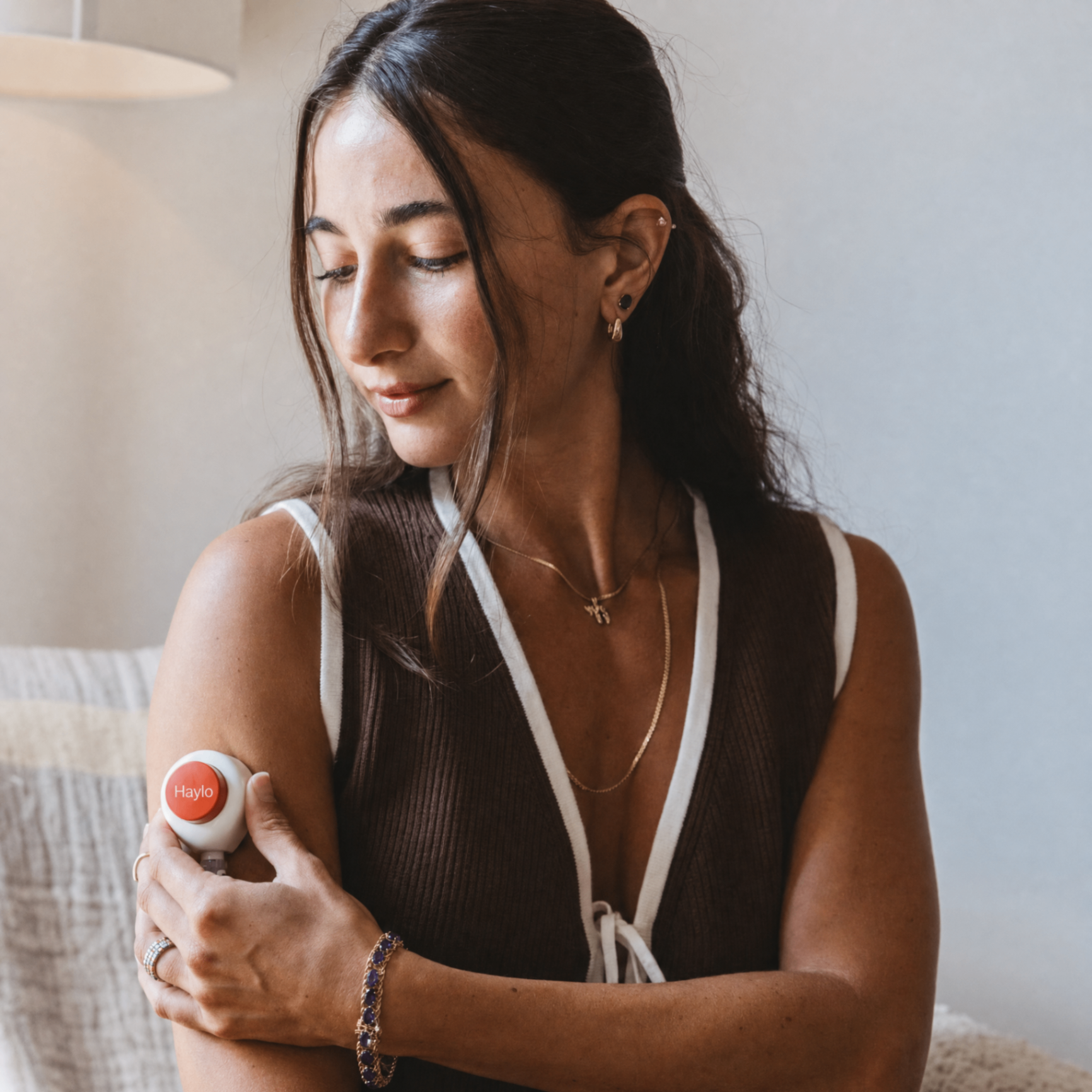 A woman using the Haylo device at home